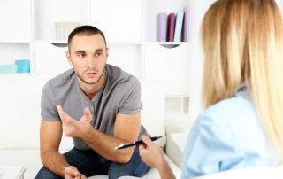 goodencenter-the-connection-between-mental-illness-and-substance-abuse-photo-of-a-Young-man-on-reception-at-psychologist