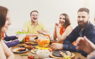 goodencenter-Nutrition-and-Mental-Health-photo-of-Young-people-having-fun-at-dinner-with-friends