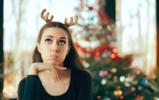 goodencenter-How-to-Maintain-Your-Mental-Health-over-the-Holidays-photo-of-a-sad-and-bored-beautiful-woman-on-christmas-day